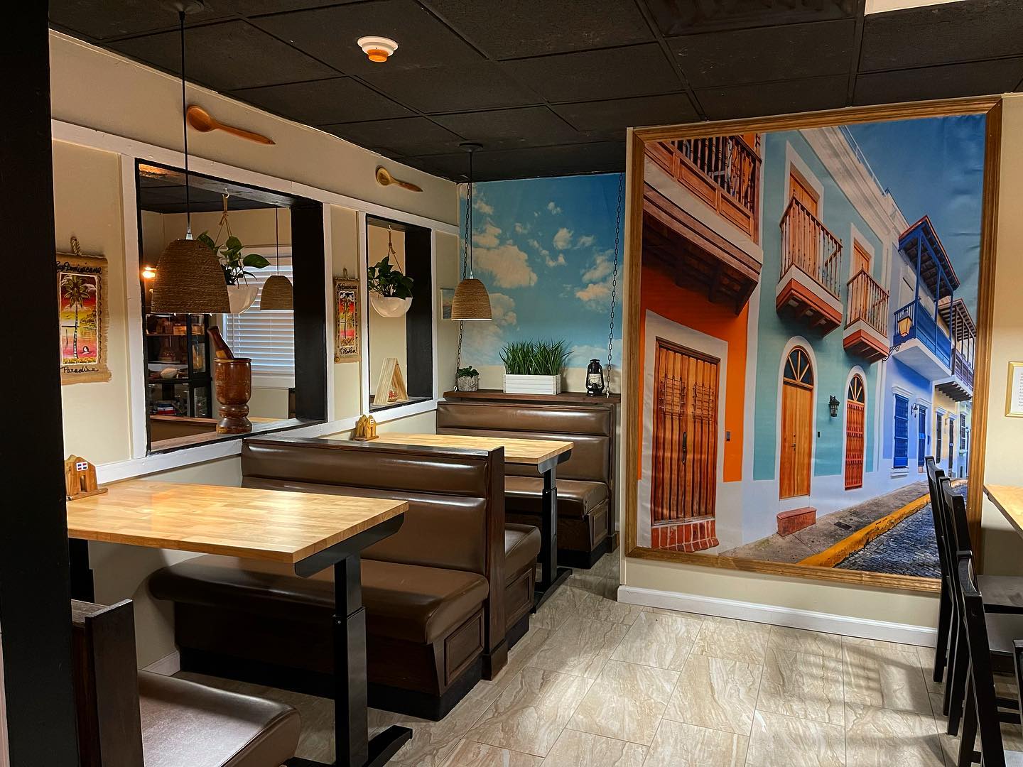 Cozy wooden booths next to a vibrant Old San Juan street mural