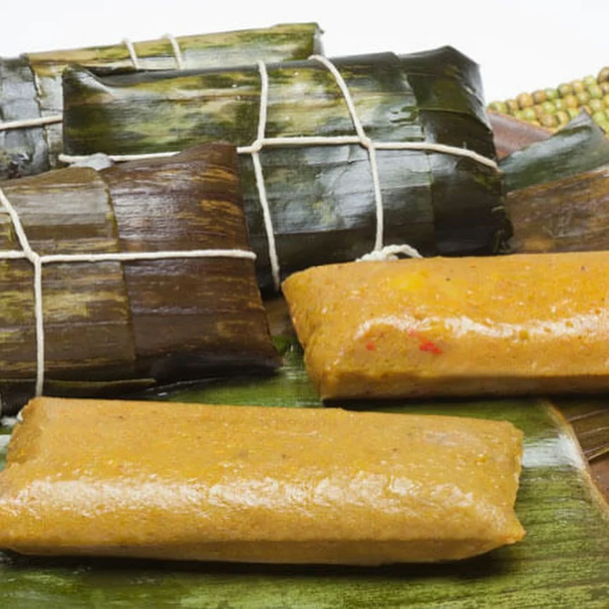 Traditional pasteles wrapped in banana leaves at Caribe